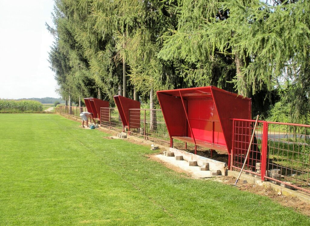 The long side o with the dugouts of the stadium (football pitch or sports field) „Nogometno igralište Trnoc“ of the Croatian football club NK Podturen on the street “Školska”, which branches off from the street “Čakovečk